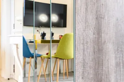 a room with two chairs and a table and a tv at Casa Vacanze Marrucini in Rome