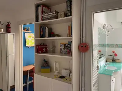 a room with a book shelf with a sink and a desk at Family Apartment by Metro A Vatican Museums in Rome