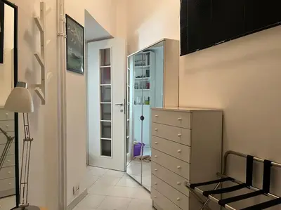 a room with a dresser and a closet with a mirror at Family Apartment by Metro A Vatican Museums in Rome