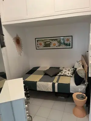 a small bedroom with a bed and a toilet at Family Apartment by Metro A Vatican Museums in Rome
