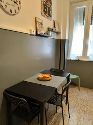 a table with a pizza sitting on top of it at A casa di Gi in Rome