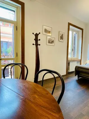 a dining room with a wooden table and chairs at Martina al Colosseo in Rome