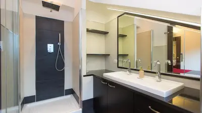a bathroom with a sink and a shower and a mirror at Panorama Penthouse by Rental in Rome in Rome