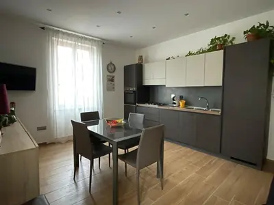 a kitchen with a table and chairs in a kitchen at Fabio´s Holiday House in Rome