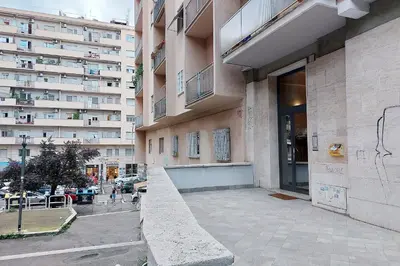 a large building with a ramp in front of it at Carmens Flat by DomusDimore in Rome