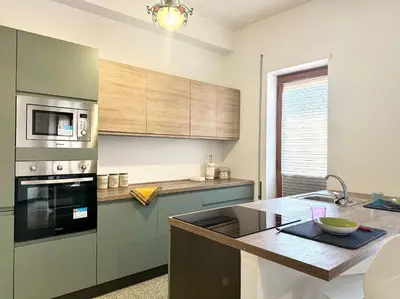 a kitchen with stainless steel appliances and a counter at Lungotevere Cozy Nest in Rome