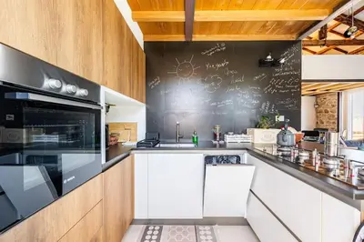 a kitchen with a chalkboard on the wall at Loft in Garbatella in Garbatella
