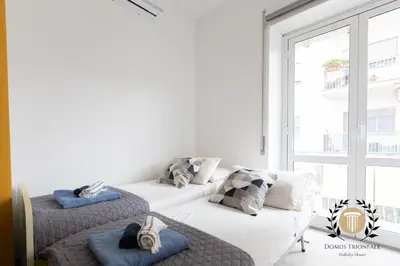 two beds in a room with a window at Domus Trionfale - 8 min walk to Vatican, 500mt to Metro A, A-C in Rome