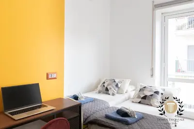 a living room with a couch and a laptop on a desk at Domus Trionfale - 8 min walk to Vatican, 500mt to Metro A, A-C in Rome