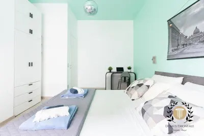 a bedroom with a large bed with a picture on the wall at Domus Trionfale - 8 min walk to Vatican, 500mt to Metro A, A-C in Rome