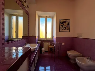 a large bathroom with two sinks and two toilets at Green Oasis in Villa Riccio in Rome