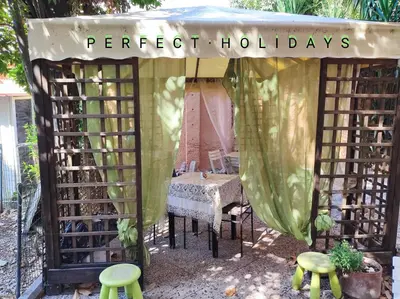 a gazebo with a bed and a table and chairs at Tucci's Roma Guest House in Rome