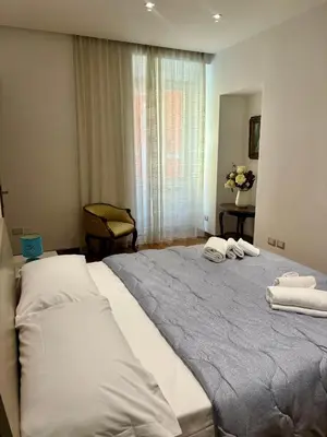 a bedroom with a large bed with towels on it at Dimora Sistina Roma in Rome