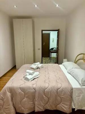 a bedroom with a large bed with towels on it at Dimora Sistina Roma in Rome