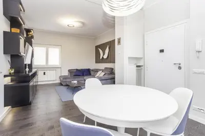 a white living room with a white table and chairs at Elegant apartment metro A - by OpenRoma in Rome