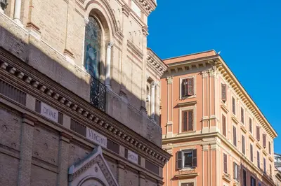 a tall building next to a building with a window at Repubblica Apartment in Rome