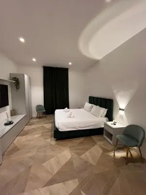 a bedroom with a bed and a table and a chair at Luxury apartments, Piazza di Spagna in Rome