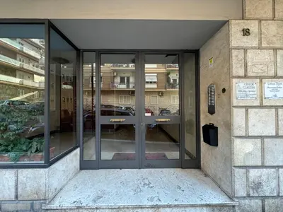 an entrance to a building with glass doors at Dolce Vita House - 10min walk to Vatican in Rome