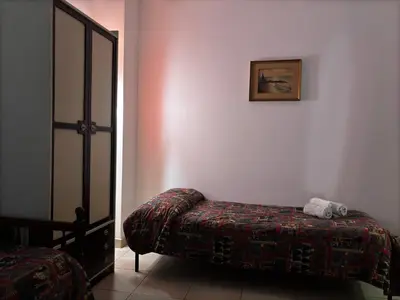 a bedroom with a bed and a picture on the wall at Vodice Apartment- Between Vatican and Foro Italico in Rome