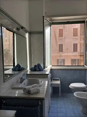 a bathroom with a sink and a toilet and a window at Vodice Apartment- Between Vatican and Foro Italico in Rome