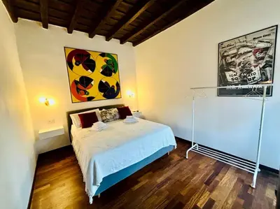 a bedroom with a bed and a painting on the wall at Scala 31 Trastevere in Rome