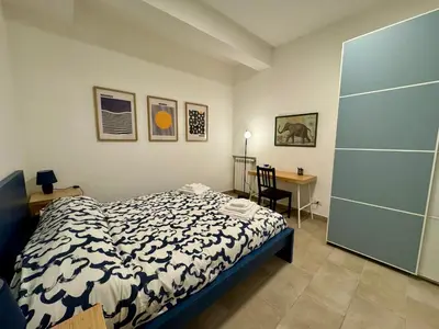 a bedroom with a bed and a desk at Trastevere Cozy Retreat in Rome
