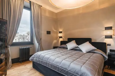 a bedroom with a bed and a large window at Mega Royal Suite in Rome