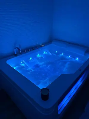 a blue bathtub with a blue light in a bathroom at Vatican Home 168 in Rome