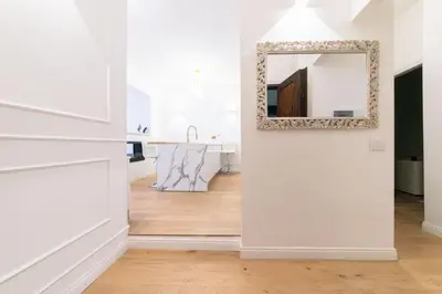 a hallway with a mirror on a wall and a sink at Vatican Home 168 in Rome