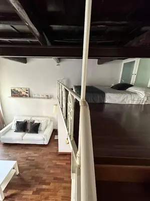 a room with a bunk bed and a couch at Tata Home Monti in Rome