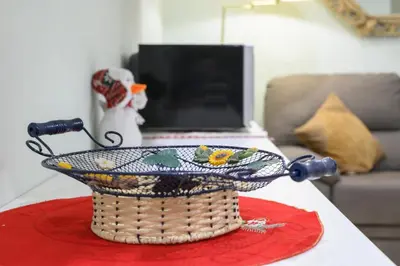 a table with a basket on a table with a laptop at 