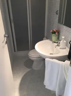 a bathroom with a toilet and a sink with towels at Affitti brevi Colosseo 2 in Rome