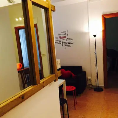 a living room with a mirror and a couch at Affitti brevi Colosseo in Rome