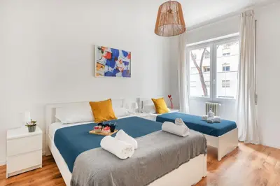 a bedroom with two beds and a window at Trieste Home! in Rome