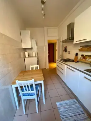 a kitchen with a table and a table and chairs at Lovely Apartment near metro A Re di Roma in Rome