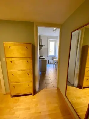 a living room with a dresser and a mirror at Lovely Apartment near metro A Re di Roma in Rome
