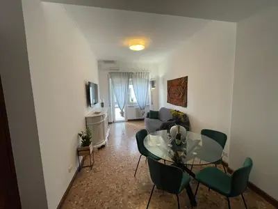 a balcony with a table and chairs and plants at La Magnolia Monteverde Apartment in Rome