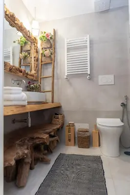 a bathroom with a sink and a toilet and a mirror at Primo Piano Suites Garden in Rome
