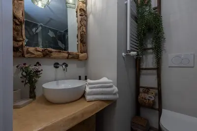 a bathroom with a white sink and a mirror at Primo Piano Suites Garden in Rome