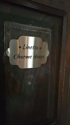 a sign on a door with a coffee cup on it at Linetta Charme House in Rome