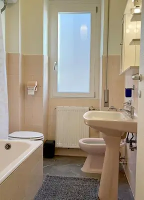a bathroom with a sink and a toilet and a window at Peter House in Rome