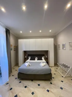 a bedroom with a bed with two pillows on it at Ezio29 Holiday House in Rome