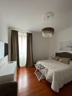 a bedroom with a bed and a desk and a window at Ezio29 Holiday House in Rome