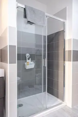 a shower with a glass door in a bathroom at Roma centro Vicino al Vaticano - Free WiFi in Rome
