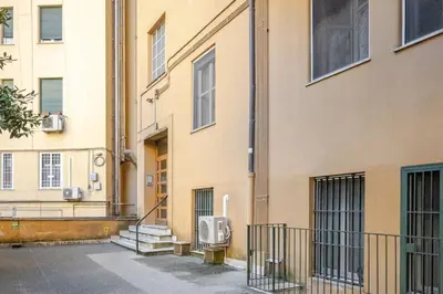 a building with a gate next to a building at Roma centro Vicino al Vaticano - Free WiFi in Rome