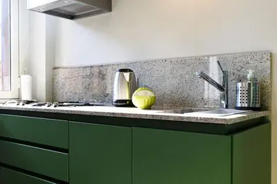 a kitchen with a green counter top with a sink at Casa Sardi in Rome