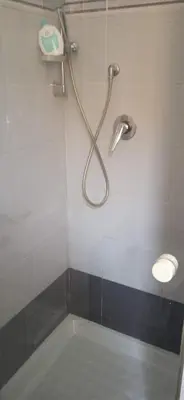 a shower with a shower head in a bathroom at InsideRome Appartamento Vaticano e Centro Storico in Rome