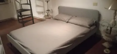 a small bed in a room with a ladder at InsideRome Appartamento Vaticano e Centro Storico in Rome