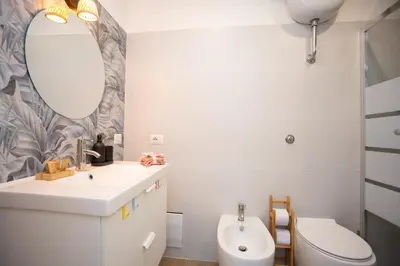 a bathroom with a sink and a toilet and a mirror at Da Cesare e Chloe al Colosseo in Rome