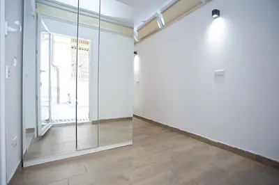 an empty room with a glass door and a window at Da Cesare e Chloe al Colosseo in Rome